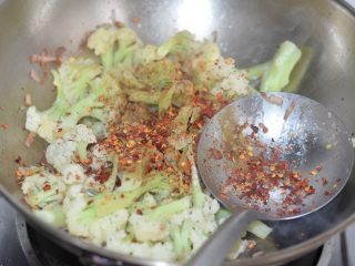 孜然花菜，比肉还好吃！,倒入辣椒碎，碎片状辣椒最好。