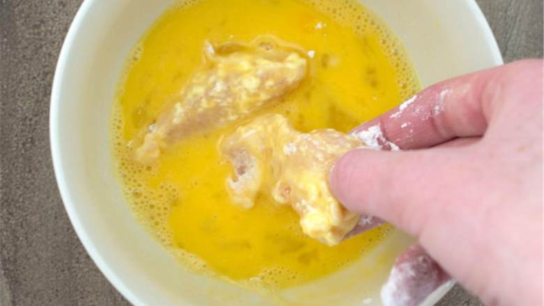 烤鸡肉卷,将包着面粉的鸡肉放入鸡蛋混合物中，要保证移到第三步的时候蛋液不会滴落。