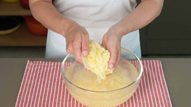 炸薯饼佐煎蛋培根,将土豆丝放在冷水中浸泡，不时搅动直到水变得浑浊。换新水冲洗土豆丝后将其铺在厨房毛巾上，用毛巾吸走尽可能多的水分。将土豆丝重进放入碗中，摇晃大碗使土豆丝分开，然后再次将它们铺在毛巾上最后一次吸水。