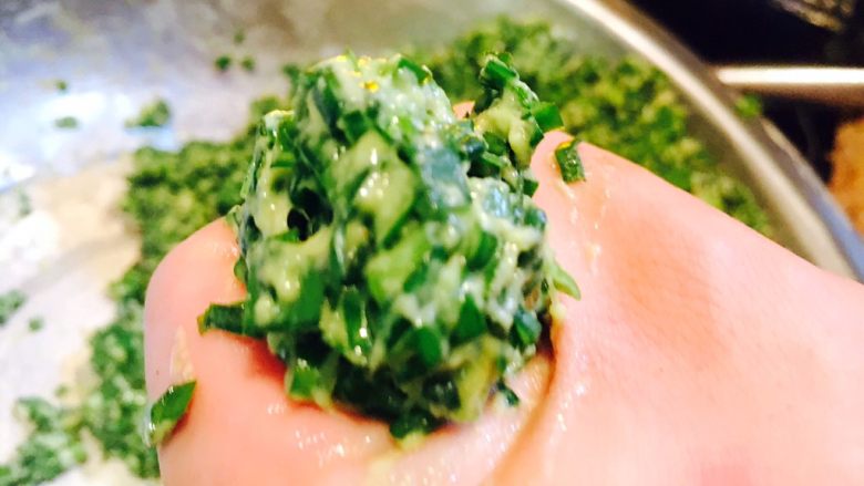 韭菜小圆子,用手抓住一团韭菜糊，从虎口挤出直径约4～5厘米左右的小圆子，放入油锅中。