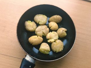 椒盐土豆,大火热锅放油，一定要等到油冒烟，放下土豆会有“滋啦”的声音才算是煎土豆。土豆一个个码好。