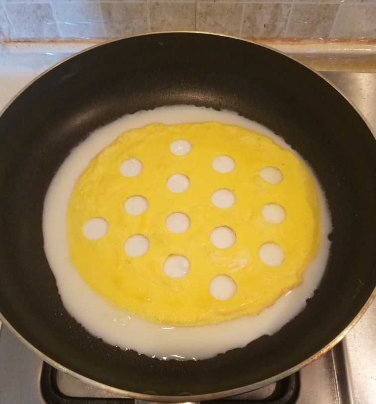 波点蛋包饭,蛋清液表成未完全凝固时就将蛋黄饼放入，这样可以很好的粘合在一起。