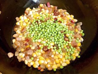 土豆腊肉焖饭,放入玉米粒，豌豆一起翻炒。