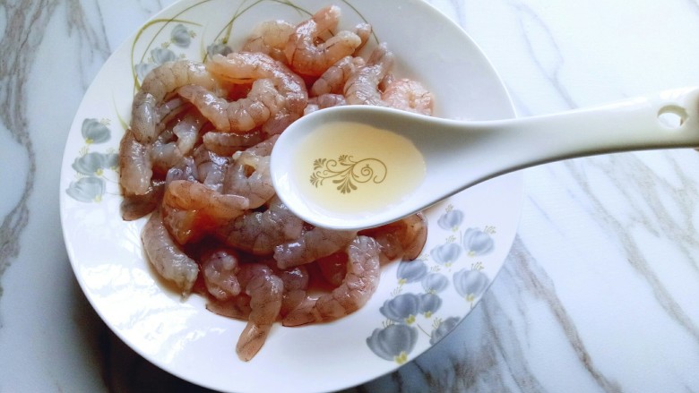 #东南亚风味的#椰汁咖喱虾,洗干净的虾仁放入盘子中，加入一勺料酒。