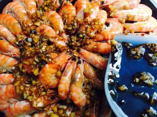 蒜蓉铁板虾,调好的酱汁均匀的浇到虾上面