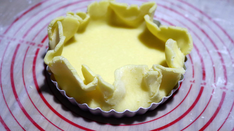 黄桃乳酪派,将面皮放在模具中，底边压到底，派盘底部和侧面的面团要贴合这个角度，不要留空隙。
