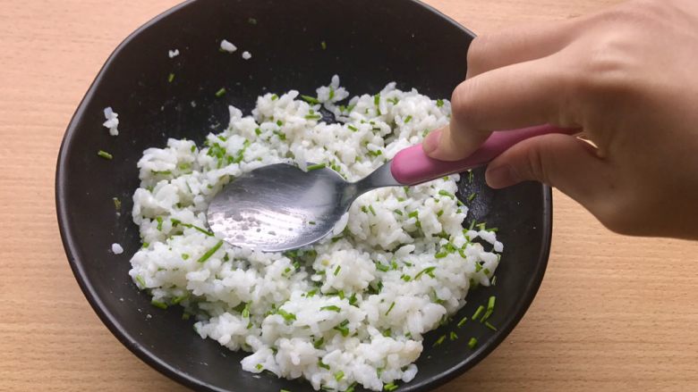 香甜米饭-葱香粢饭糕,用勺子去压米饭和葱，让粘稠的米饭更加粘稠。
