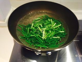 蒜苔肉丝,水开，放入蒜苔，撒少许盐，可以保持翠绿