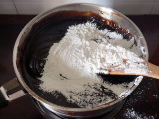枣泥月饼,炒至水份七成干的时候，加入糯米粉，翻炒均匀。