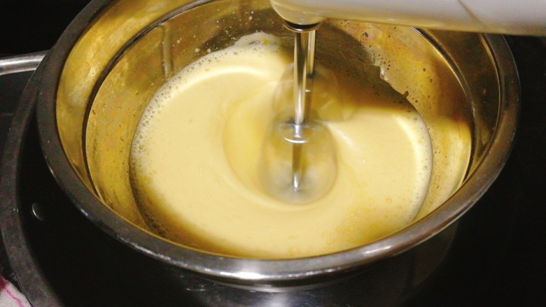 无油版水蒸蛋糕,将打蛋盆坐在温水盆中隔水打发。