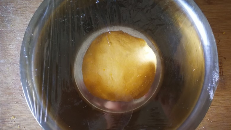 千层手撕南瓜馒头,揉成光滑的面团盖上保鲜膜放盆里等待发酵。