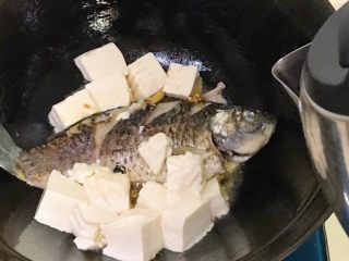 浓汤鲫鱼炖豆腐,倒入烧开的水