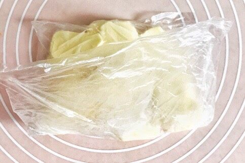 万能千层酥皮,将塑料袋对折过来，刚刚好是塑料袋一半的大小，敲打、擀平，成平整的黄油片