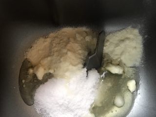 北海道中种吐司,面包机里放入主面团的糖，盐，奶粉和蛋白液。