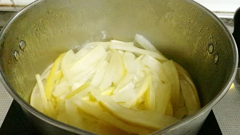 柚皮糖,将烤干的柚皮放入，中小火慢煮，使冰糖液完全浸入柚皮中，关火