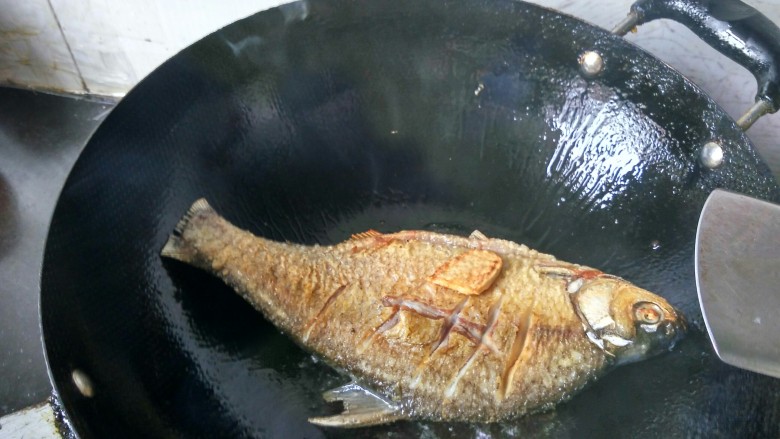 豆瓣酱烧鳊鱼,将鱼放入锅内，并将两面煎至金黄