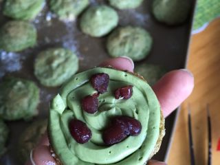 #绿色美食#抹茶红豆小圆饼干,拿一个饼反面在上，挤满馅放上几粒红豆