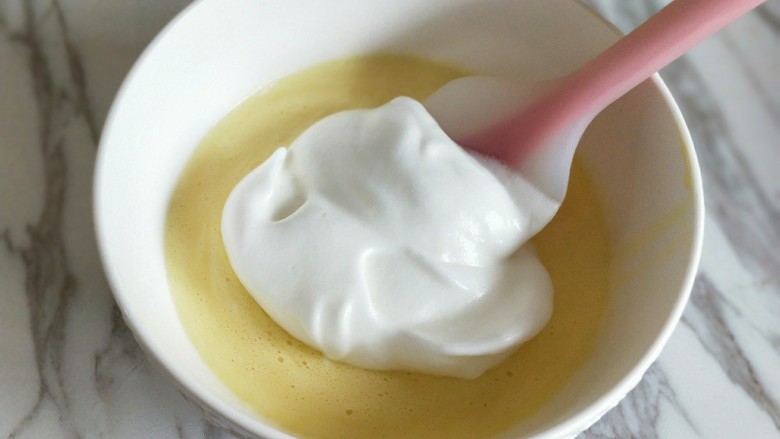 仿乳酪蛋糕【消耗淡奶油】,烤箱140度预热。
取1/2蛋白霜放入蛋黄糊中，翻拌均匀。