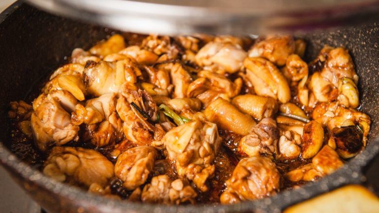 三杯鸡,翻炒均匀加锅盖中火焖煮至汤汁浓稠