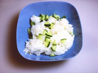 米饭鸡蛋饼 香酥脆,准备一个大碗，将米饭放入碗中，将黄瓜放入