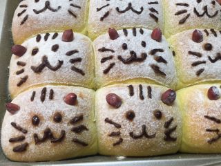 南瓜小米猫咪面包,待面包放凉后用巧克力笔挤上猫咪表情。