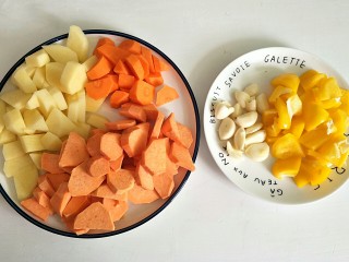 三汁焖锅,土豆、番薯、胡萝卜和彩椒切块，蒜头剥粒备用