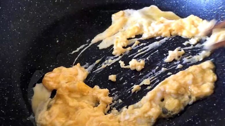 早餐 鸡蛋火腿三明治,将鸡蛋在碗中加盐打散放入锅中快速炒散