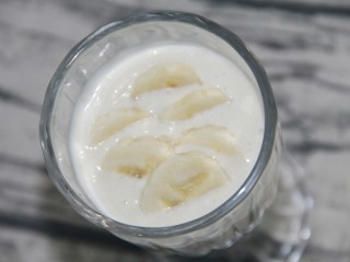 香蕉奶昔奶油杯,再倒入淡奶油，淡奶油打发增加饮品的浓度，摆上香蕉片不会下沉