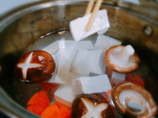 辣白菜豆腐煲,汤锅清水中放入胡萝卜香菇豆腐
