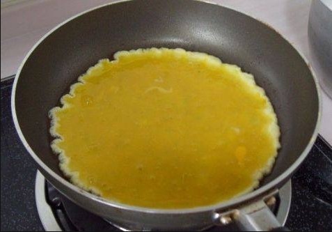 火腿肉松三明治,平底锅中倒少许橄榄油，将鸡蛋液入锅煎鸡蛋饼；