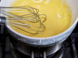 荷兰酱汁,把蛋黄柠檬碗坐在锅上，注意，碗底不能接触水，要利用沸水的蒸汽加热，并且不断搅拌，搅拌至均匀细腻浓稠，不从打蛋器上滴落。