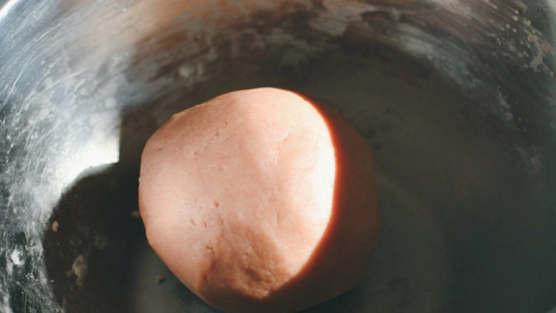 草莓酱夹“心”饼干,用手混合成面团。
包保鲜膜放入冰箱冷冻半小时。