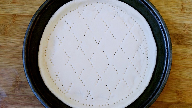 八寸披萨饼饼胚,饼中间也用叉子扎孔，形状随意。