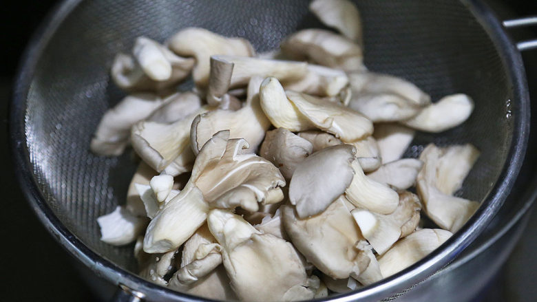 双菇炒肉片,将平菇和真姬菇用20cm滤网勺盛起，放入开水中烫30秒