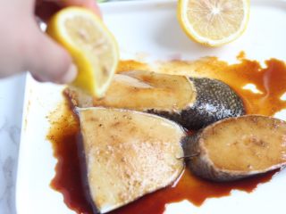 红酒柠香银鳕鱼,撒上白胡椒粉3g，滴上几滴柠檬汁，淋上一汤匙生抽，腌制十五分钟。