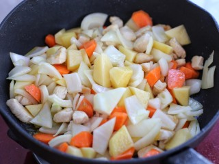 鸡肉咖喱饭,再放入土豆、胡萝卜和洋葱翻炒均匀