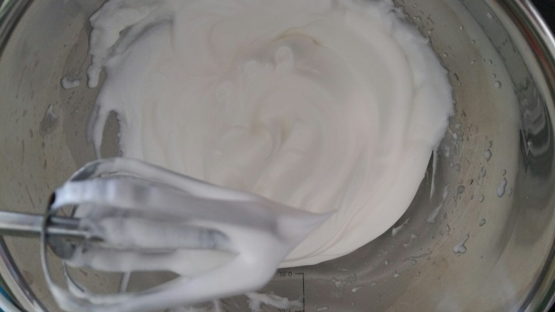 戚风杯子蛋糕,蛋白打发至出现弯弯的小尖勾时加入剩余白糖。