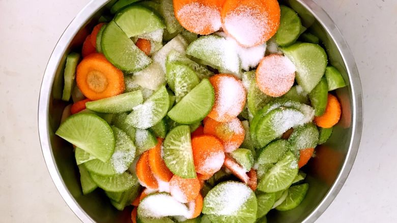 开胃小菜 脆爽萝卜,把绿萝卜片和胡萝卜片放入盆中，加入精盐