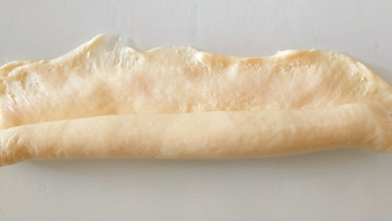 黄桃面包,从侧面卷起另一边用手压薄