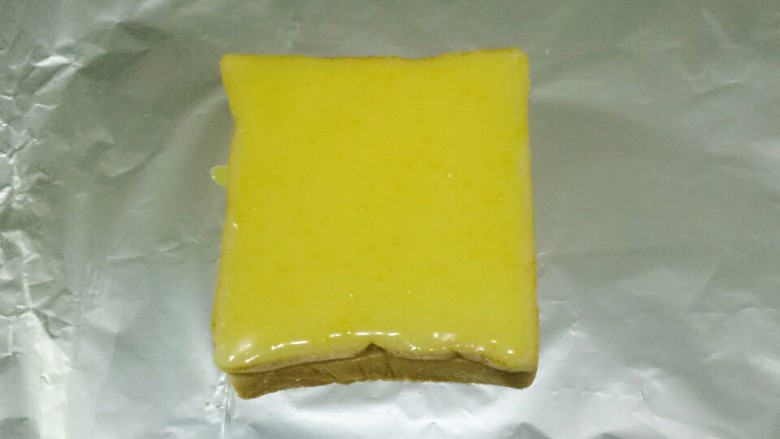 岩烧乳酪,用勺子舀适量浆液浇在土司上，涂抹厚厚的一层