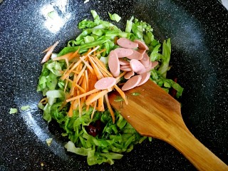 洋白菜炒粉丝,洋白菜变色以后，放入切好的胡萝卜丝和火腿肠
