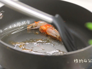 鸡蛋豆腐鲜虾羹,倒入稍微多一点油，中小火炸虾头。炸的时候用铲子压一压虾头。
