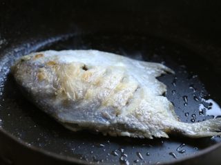 蒜香鲳鱼,炒锅内倒入适量油，烧到七八成热，放入抹好淀粉的鲳鱼，中小火慢煎至鱼身两面金黄，将鱼盛出。