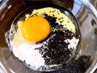 煎藕盒,接下来调一碗面糊，容器加入面粉，熟黑芝麻，一个鸡蛋
