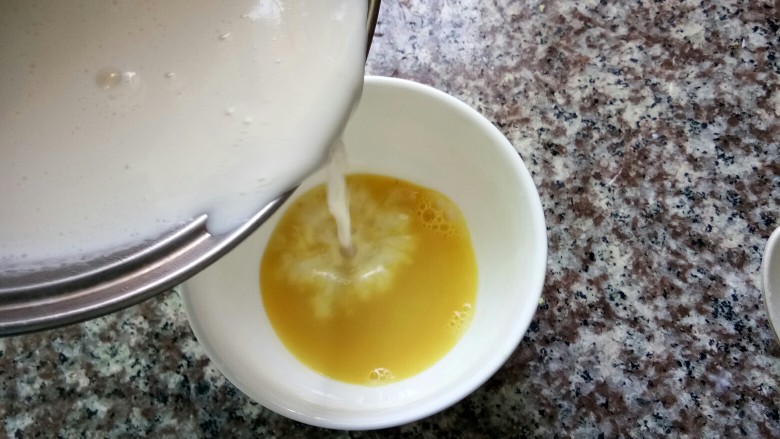 姜撞奶,接着将煮好的牛奶快速倒入姜汁里。