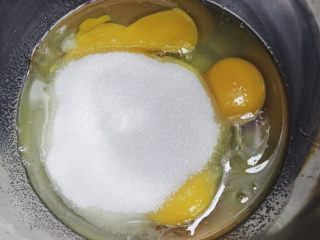 圣诞玛德琳,将蛋和细砂糖倒入到盆子里，搅拌至细沙糖完全融化。