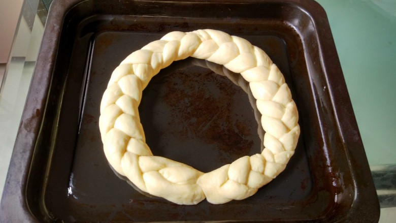 圣诞花环面包
,编好的辫子合拢成圆环（首尾捏拢粘合），放入烤盘（烤盘先刷一层油）
