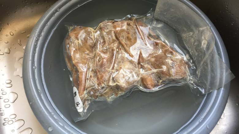 干锅土豆鸭头,将鸭头隔着包装袋冷水解冻；