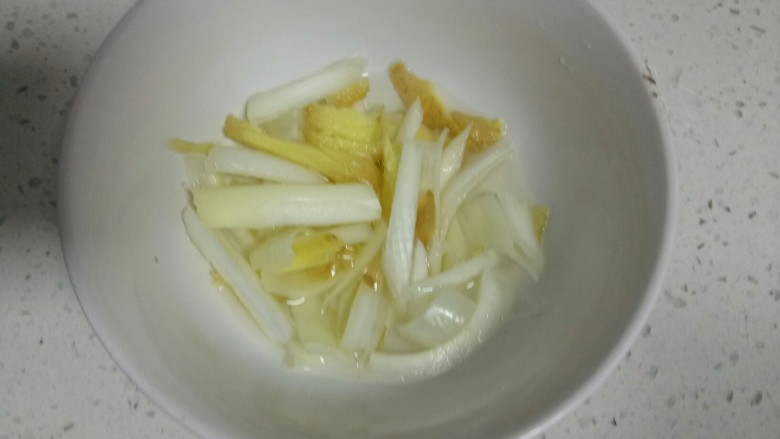 自制鱼丸,葱、姜切成细条放入碗中，加入适量水。