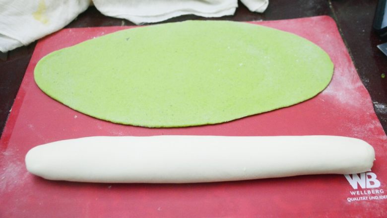 翡翠菠菜饺子,醒发好的面团拿出揉好，绿面团用擀面杖擀成椭圆的一快面皮，白面团揉成长条的面团